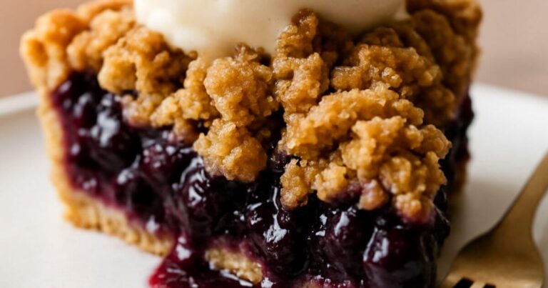 Freshly baked blueberry crumble pie with golden, buttery topping – the ultimate summer dessert