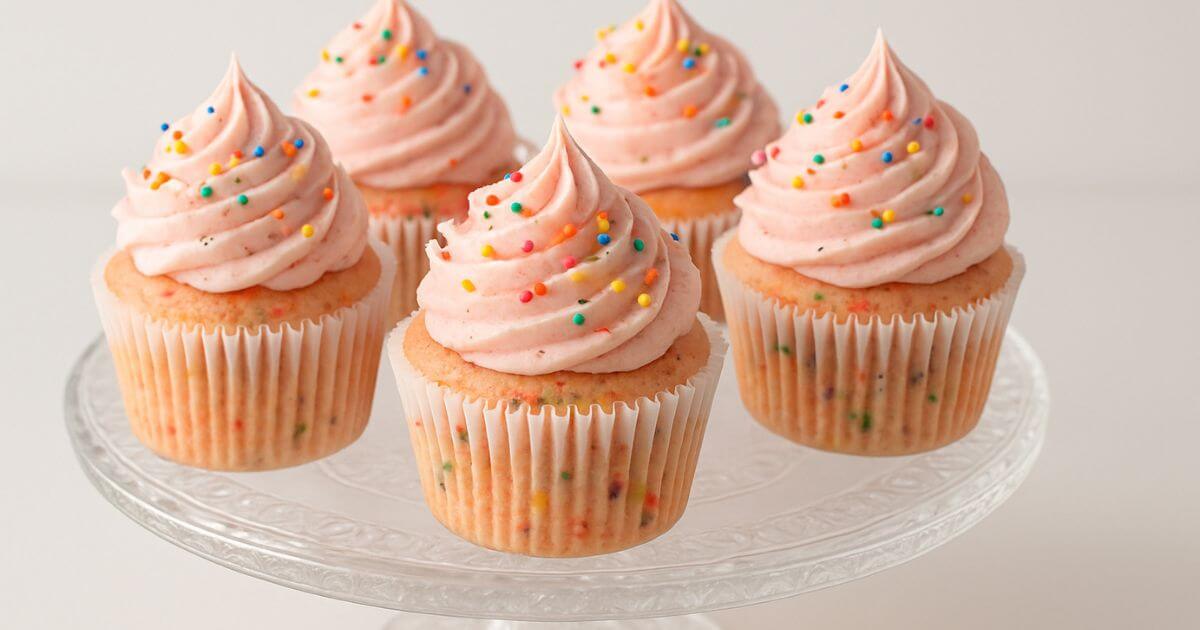 strawberry confetti cupcakes topped with pink frosting and sprinkles, perfect for party celebrations