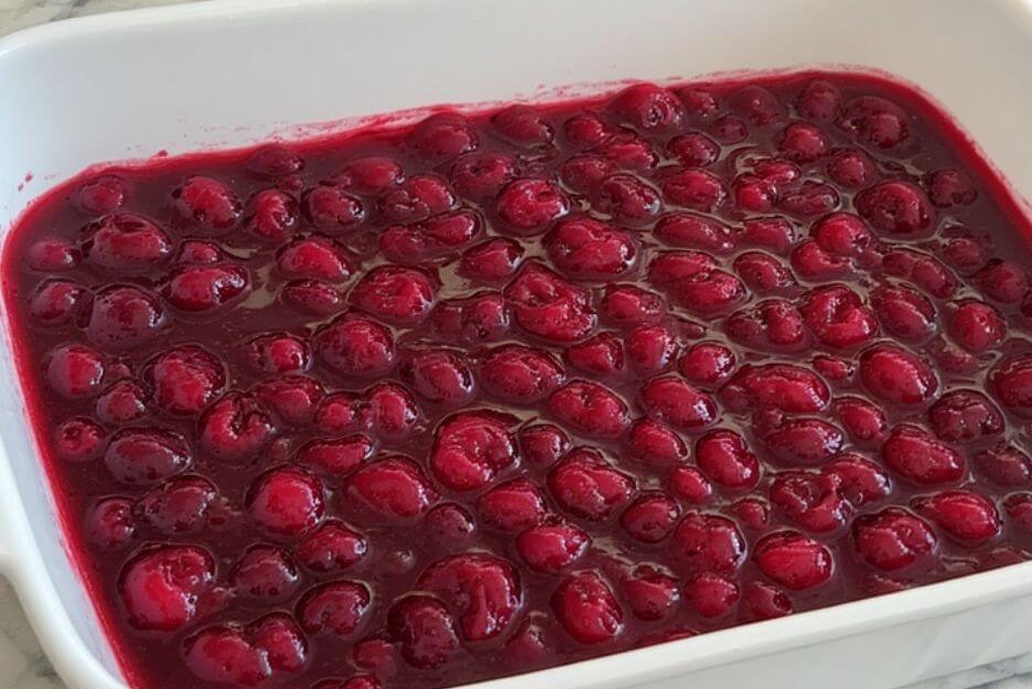 Empty both cherry filling cans into your greased baking dish