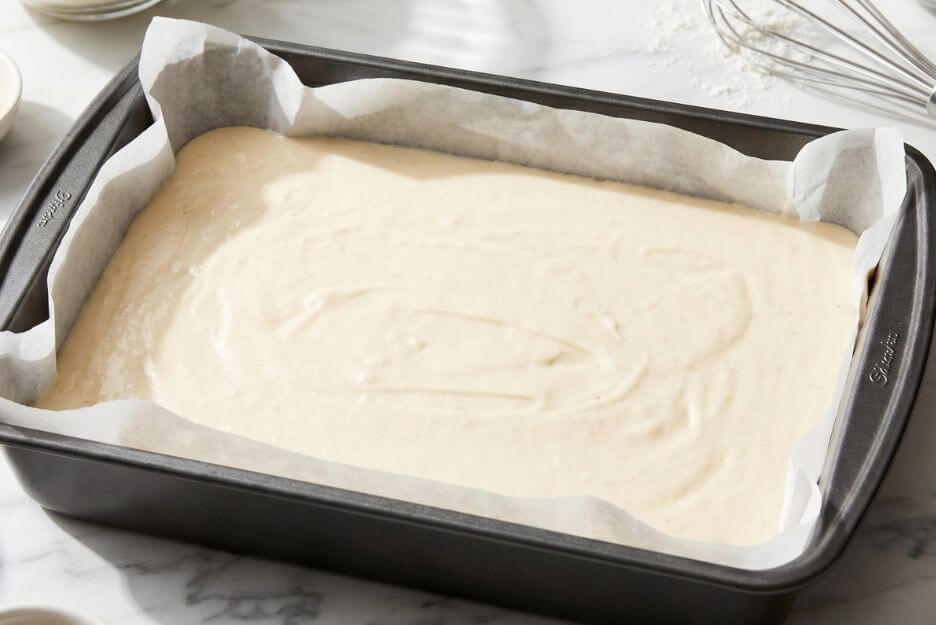Pour the batter of Vanilla Sheet Cake into your prepared pan