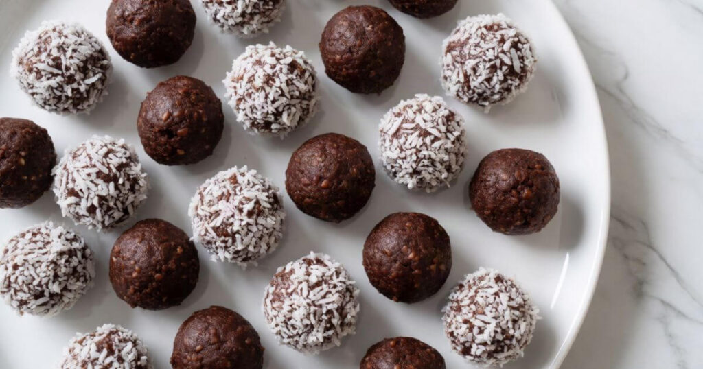 No-Bake Brownie Bites You Can Make in 15 Minutes coated in shredded coconut on a white plate