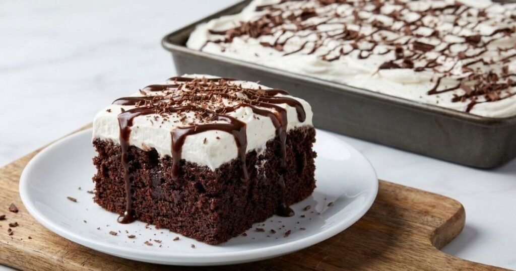 Chocolate poke cake for chocolate lovers topped with whipped cream and chocolate drizzle